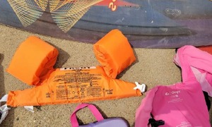 lot 58 image: SwimmingBoating Lot - 4 boat throttles, wake boogie board, life vests, vintage life saving books, boat bumpers, floating drink holder and kids swim finsetc.