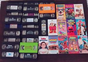 lot 114 image: 34 PC VHS Set w Elmo, Dragon Tales, Penguins, Shrek, Sponge Bob, Dora, Rugrats, Walt Disney Fun and Fancy Free, Etc