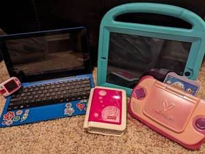 lot 106 image: Mixed Tech Lot w VTech VSmile Cyber Pocket and Zayzoo An Earth Adventure Game, Tablet and iPad Case, RCA Windows Cambio, and LeapFrog LeapBand Watch - QV DESCR