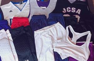lot 84 image: 13 Pc Sports Clothing (YL-M) w Mavricks Nowitzki Jersey, 2 Sets of McDavid Knee Guards (White and Black Set), Jerseys, Under Garments, and Athletic Shorts