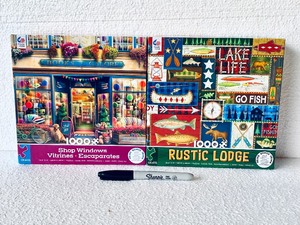 lot 184 image: Lot Of 2 New - Ceaco (1) Rustic Lodge & (1) Shop Windows Puzzle Sets, 1,000Pc Each Box - As Shown