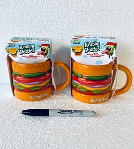 lot 297 image: Lot Of 2 - New Spongebob Squarepants Krabby Patties Mug with 3 Krabby Patty Gummy Candies Per Set - As Shown - Total Retail $44
