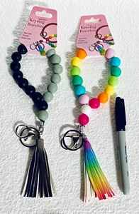 lot 411 image: Lot Of 2 New - Keyring Bracelets Silicone, Stylish & Multi-Use With Tassels - In Color As Shown - Total Retail $22