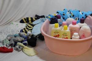 lot 77 image: Baby Bathtub, Lotions and soaps and a variety of clothes