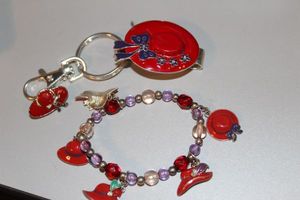lot 211 image: Matching Bracelet, Key chain, and Pedant as shown