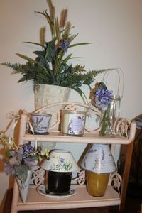 lot 49 image: Candle Holders and Purple flowers, Shelf included