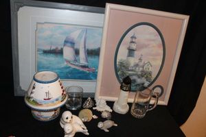 lot 29 image: Beach Themed Dcor, Light House Picture, Sale Boat, Candle with Candle Shade, Figurines and more