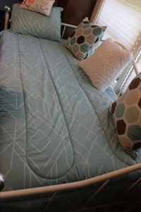 lot 86 image: Twin size day bed, trundle, all bedding pictured, and pillows mattresses avalable and to go with, two twin these are like new, hardly used at all