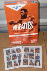 lot 311 image: Unopened Muhammad Ali Wheaties Box and Stamps