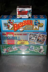 lot 303 image: Factory Sealed Topps 1992 Traded Baseball Cards, Topps 1994 Compete Set of Series 1 & 2, Donruss Baseball Puzzle and cards