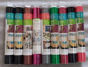 lot 286 image: YOUR BID X 9 NEW, UNOPENED CRICUT VINYL ROLLS IN ASSORTED COLORS AND STYLES AS SHOWN.