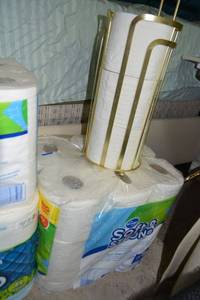 lot 100 image: 3 unopened packages of toilet paper plus gold colored TP holder