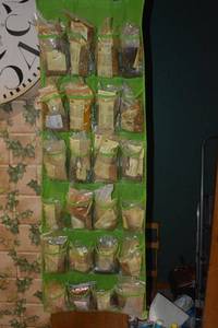 lot 125 image: Assorted Penzeys Spices in and blends in a hanging door storage unit that rolls up for easy transport.