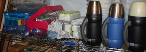 lot 154 image: LocknLock containers, Thermos insulated beverage bottles, unopened ice cube trays, water purification drops, mobile clothes washer, and plastic water bottles