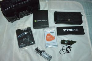 lot 94 image: Coach Wallet, STRIKEPEN, Identity Stronghold Wallet, USMC mini knife, Survival Compass, RFID Sheath Protectors with Black Bag