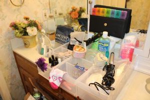 lot 363 image: Pill organizer, curling iron, travel steamer, bath salts, flower arrangement and more