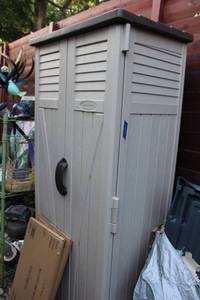 lot 404 image: Suncast 2x2 Resin vertical Storage building. Includes 2 wire shelves unopened in box. Click on lot to see link provided for more information.
