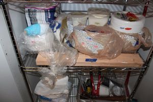 lot 272 image: Paper Plates, napkins, LocknLock containers with sugar, plastic spoons, tools in basket as shown