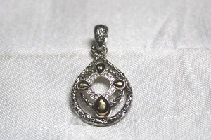 lot 217 image: Signed Jai Sterling silver pendant with 14K yellow gold accents. Marked JAI 925 14K. Large hinged bale. 1.5L