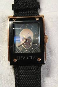 lot 9 image: Signed Invicta skull motif watch with domed crystal. Technofiber band. Model 4834