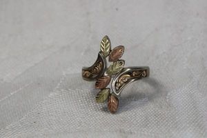 lot 12 image: Signed Black Hills Gold tri color ring. Marked CCO Sterling 10K. Size 7