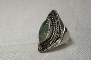 lot 19 image: Sterling Silver gemstone Prehnite ring with black pyrite needle inclusions. Marked 925. Size 7.25