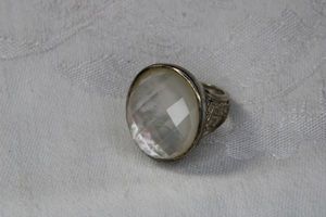 lot 30 image: Sterling Silver Mother of Pearl and cushion cut Quartz dome ring with Celtic shoulder design. Marked 925 WR. Size 8