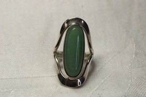 lot 32 image: Signed QVC Dominique (Mintz) Dinouart (Taxco Mexican Silversmith, Vermont, 1984 - ) Modernist Jadeite cabochon ring. Size 8. Marked DDD 925. Jadeite tested