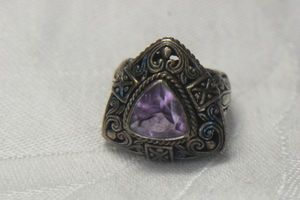 lot 37 image: Sterling Silver trillion cut Amethyst ring. Marked 925. Size 7
