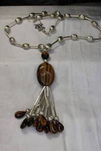lot 53 image: Sterling Silver and Tigers Eye tassel necklace. Marked BL 925. Toggle clasp. 22L with figural lizard clasp decoration. Overall length 30L.