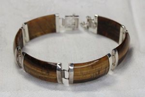 lot 54 image: Sterling Silver and Tigers Eye panel bracelet. Marked 925. Hidden box clasp with 2 safety catches. 7.5L
