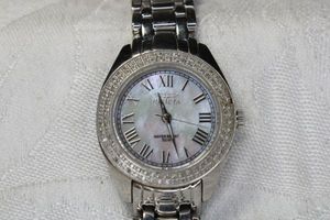 lot 57 image: Invicta diamond watch with Mother of Pearl face. Swiss made. Model 3669. Strap needs attention. Diamonds tested. Approx 1.0 cttw
