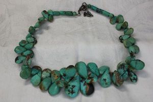 lot 58 image: Sterling Silver and pear shape Turquoise necklace. Marked 925 on clasp. 16L with 2 extender