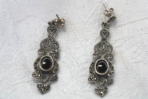 lot 69 image: Sterling Silver marcasite and Black Onyx cabochon post earrings. 2L Marked 925 on butterfly backs