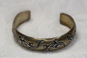 lot 73 image: Signed B Webb Sterling Silver Navajo cuff bracelet with lizardssalamander motif. Marked B. Webb