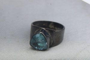 lot 75 image: Sterling Silver wide band ring with trillion cut Blue Topaz. Marked 925. Size 7