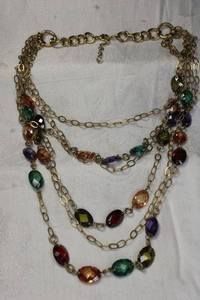 lot 84 image: Faceted colored glass station multi string tiered necklace in brass finish. Lobster clasp. 16L Overall 22L