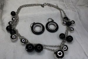 lot 87 image: Signed Kenneth Jay Lane double strand black and silver 15L necklace with hang tag and matching lever back disc earrings. All marked KJL.