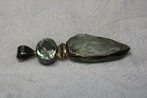lot 88 image: Sterling Silver articulated pendant with large bale featuring both polished and faceted green Quartz and rough cut specimen green Quartz. 2.75L