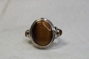 lot 96 image: Sterling Silver and Tigers Eye cabochon ring. Marked 925. Size 6.5