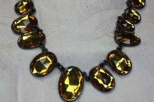 lot 104 image: Signed Joan Rivers Classic Collection 20th year anniversary gold festoon necklace in burnished finish. Has hang tag. 16L with 3 extender.
