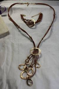 lot 107 image: Signed Blink by Kapal-Laut (India) leather cord and modernist disc necklace and bracelet set in logo pouch. Bracelet adjustable 7-8.5L, Necklace 20L