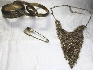lot 181 image: Tribal style brass beaded bib necklace 18L with 2 extender. Lobster clasp. Includes (3) brass brangles and modified safety pin broochpin