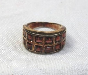 lot 180 image: Sterling Silver and Spessartine orange Garnet band ring. Marked 925. Size 9