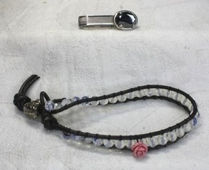lot 191 image: Leather and Moonstone bead Nakamol-style bracelet with figural angel tension bead. Also includes a Hematite tie bar.