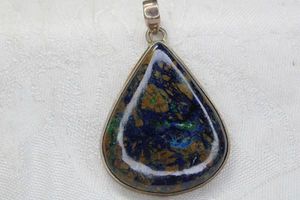 lot 133 image: Sterling Silver Azure Malachite large pendant with large bale. Marked 925. 2.25L. Includes one ear wire earring.