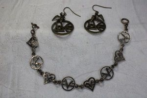lot 135 image: Sterling Silver heart and V disc link bracelet with toggle clasp. Marked 925, 8L Includes a pair of brass LOVE disc ear wire earrings with bird accents . 2L