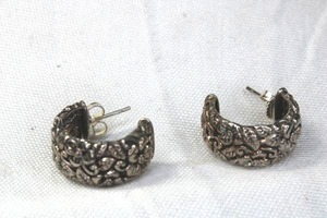lot 143 image: Signed JAI Sterling Silver half hoop post earrings with embossed flower and foliage textured exterior. Marked JAI 925 Thailand.34L