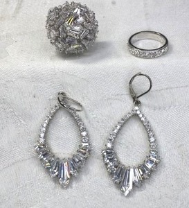lot 158 image: Diamond simulant jewelry. Includes prong set baguette dome ring Size 8, comfort fit ring Size 7 and lever back chandelier earrings 2.25L No markings