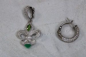 lot 214 image: Signed Judith Ripka faceted faux Emerald and CZ dangle fleur de lis pendant. Marked 925 CZ Judith Ripka on CZ decorated bale with safety catch. 1.5L (Includes single CZ hoop sterling earring, Marked 925 and a color CZ hoop (marked JR)